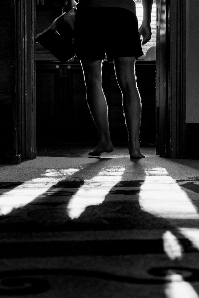 boy walking through doorway with shadows