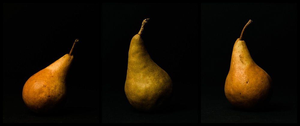 three pears in a row on a black background